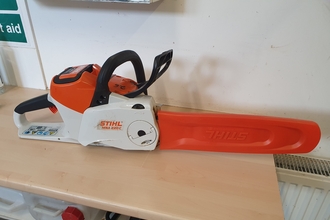 Electric chainsaw on a table by Sean Webber