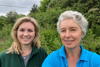 Two women looking and smiling at the camera