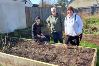 Charlotte and Kate stood with Trust colleague Yasmina behind a raised planter