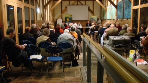 People gathered indoors for a talk