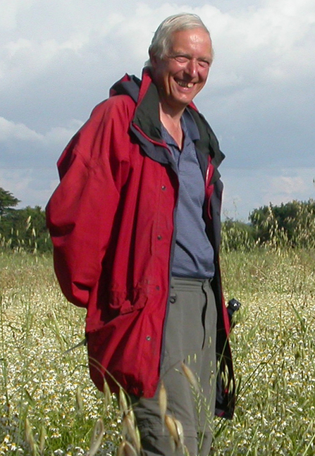 Bert Reid standing amongst flowers 