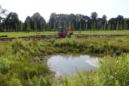 Stourport Riverside Meadow. There is an existing wetland with new works in the background.