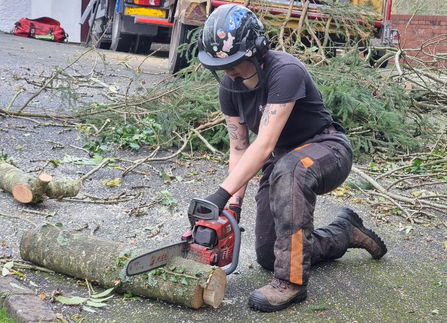 Josie practicing with her chainsaw