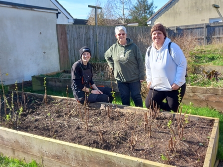 Charlotte and Kate stood with Trust colleague Yasmina behind a raised planter